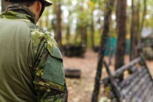 Army man walking in woods