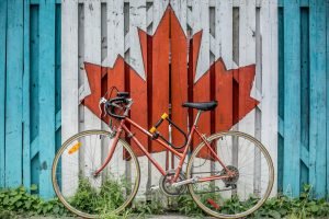 bike leaning on wall with Canadian graffiti