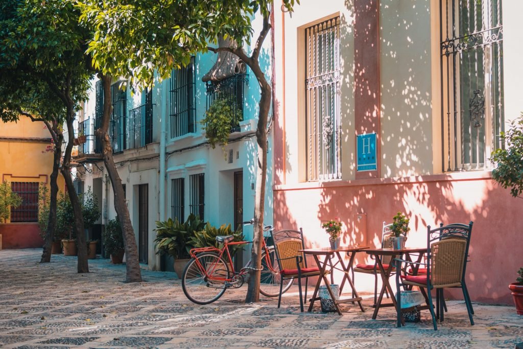 quaint street in Spain with tables, chairs and bicycle