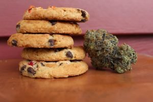 stack of cookies next to marijuana bud