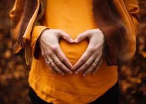 woman holding baby bump